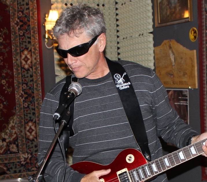 Adrian Zidaritz, playing electric guitar in a music museum in Aarhus